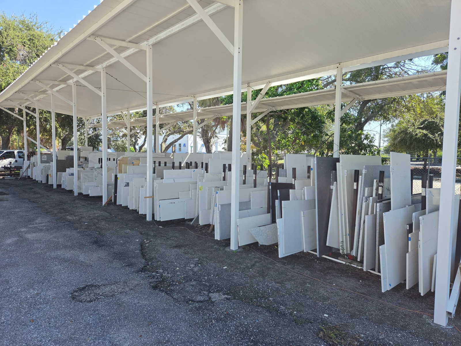 Covered racks of stone remnants at Granite Plus